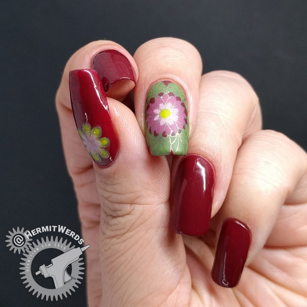 A deep red (merlot) nail art with a few brightly colored mandala decals.