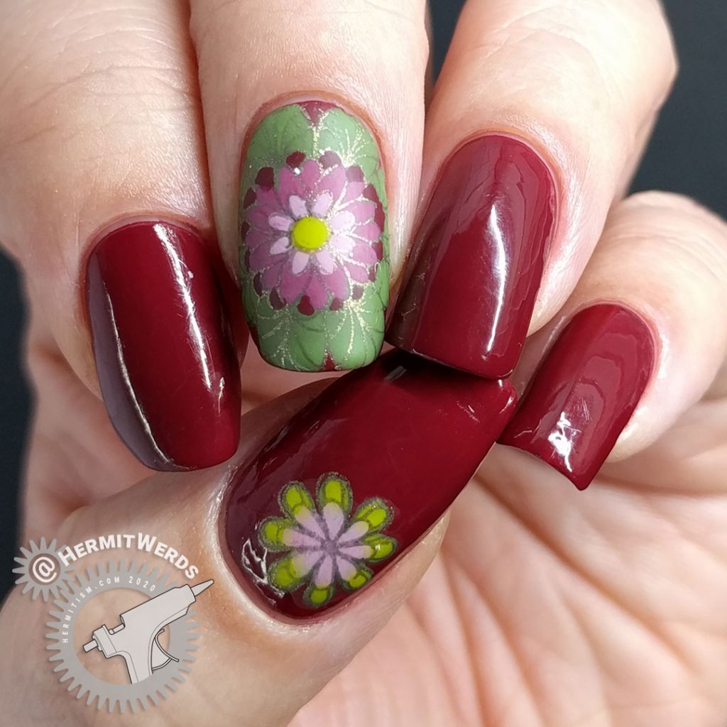 A deep red (merlot) nail art with a few brightly colored mandala decals.