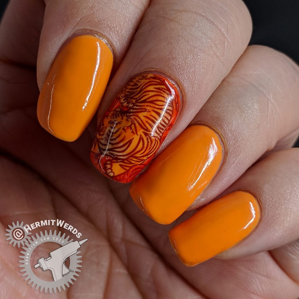 Orange nail art with a fierce tiger stamping decal inspired by Pantone's Orange Tiger color.