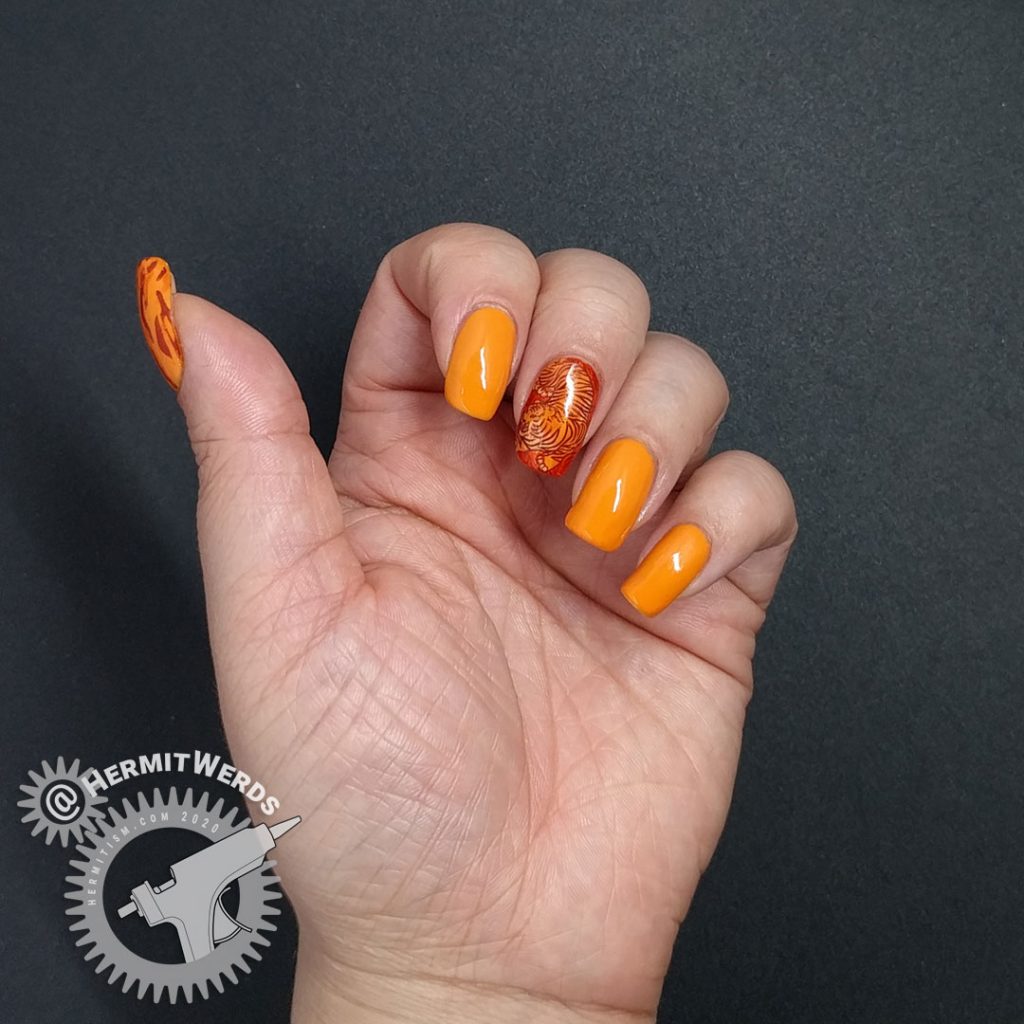 Orange nail art with a fierce tiger stamping decal inspired by Pantone's Orange Tiger color.