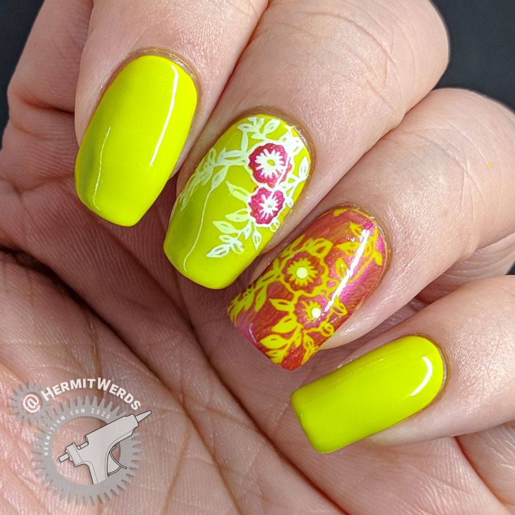 Bright green nail art with floral nail stamping in pink and white.