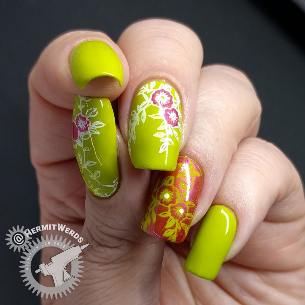 Bright green nail art with floral nail stamping in pink and white.