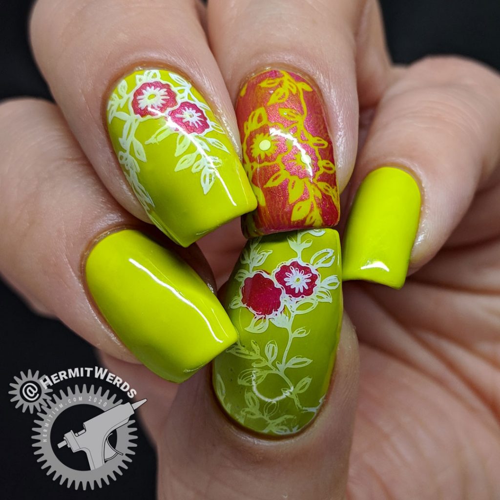 Bright green nail art with floral nail stamping in pink and white.