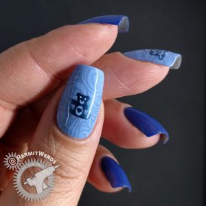 Blue monochrome nail art with Christmas presents and toys.