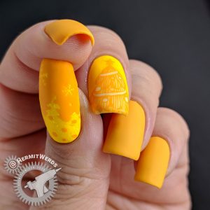 Yellow monochrome nail art of snowy Christmas trees and shimmery glitter.