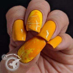 Yellow monochrome nail art of snowy Christmas trees and shimmery glitter.