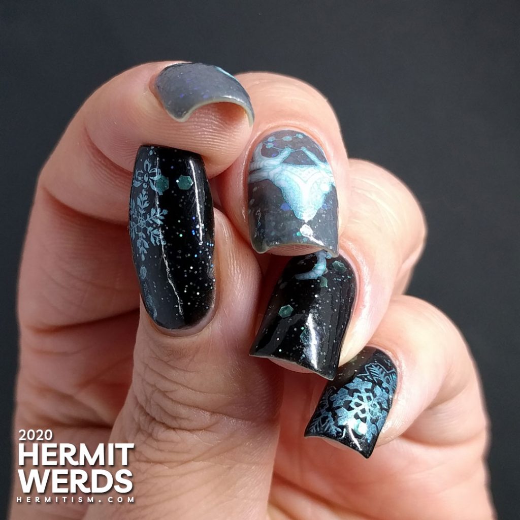 Cold, dark nail art with black and grey crellies filled with aqua hex glitter and the frosty white spirit of a deer.