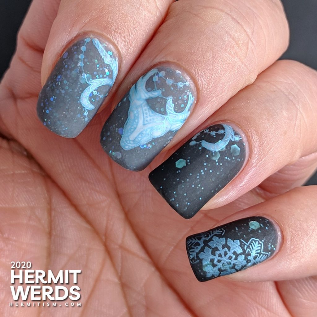 Cold, dark nail art with black and grey crellies filled with aqua hex glitter and the frosty white spirit of a deer.