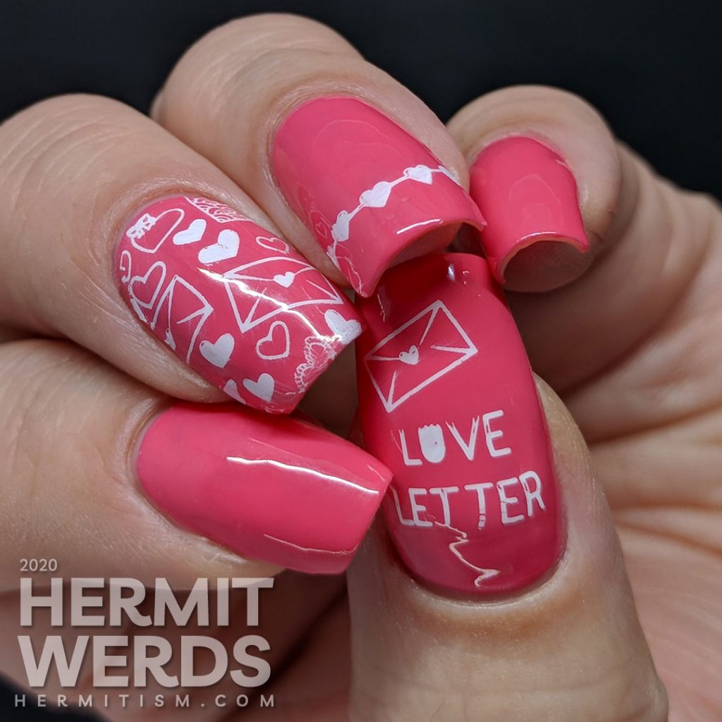 Simple and bright pink nail art with heart and love letters stamping decals.