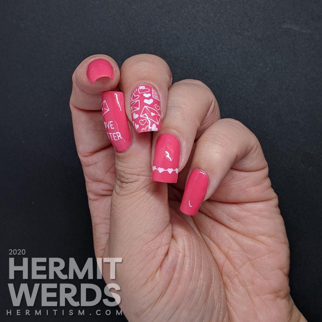 Simple and bright pink nail art with heart and love letters stamping decals.