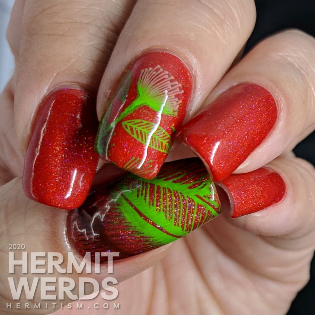 Tomato red nail art with bright green and pink stamped floral and leaf patterns.