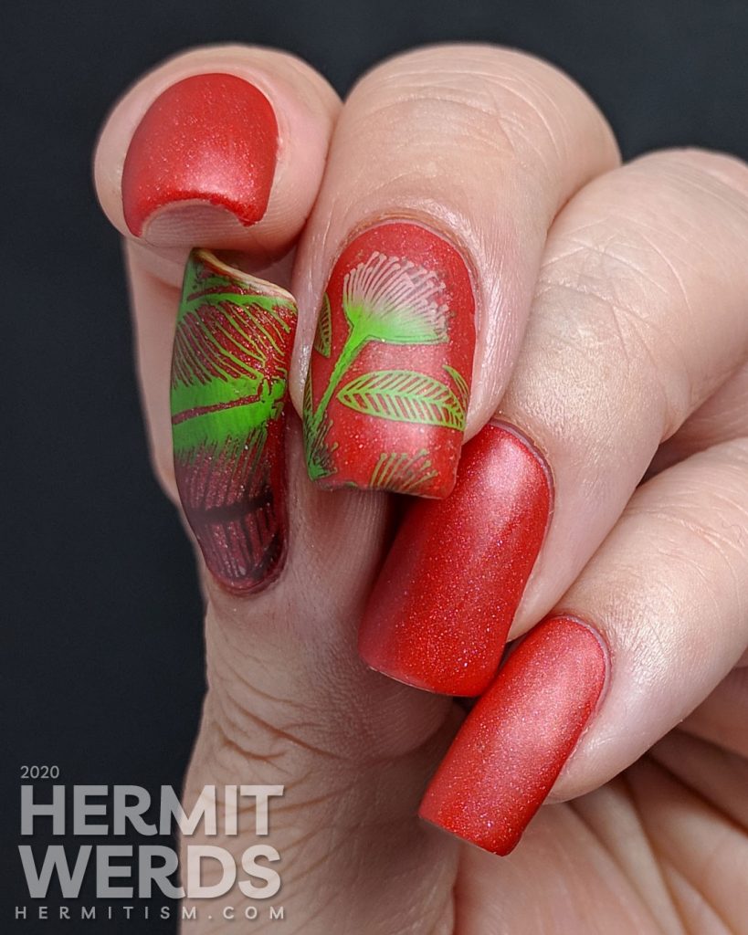 Tomato red nail art with bright green and pink stamped floral and leaf patterns.