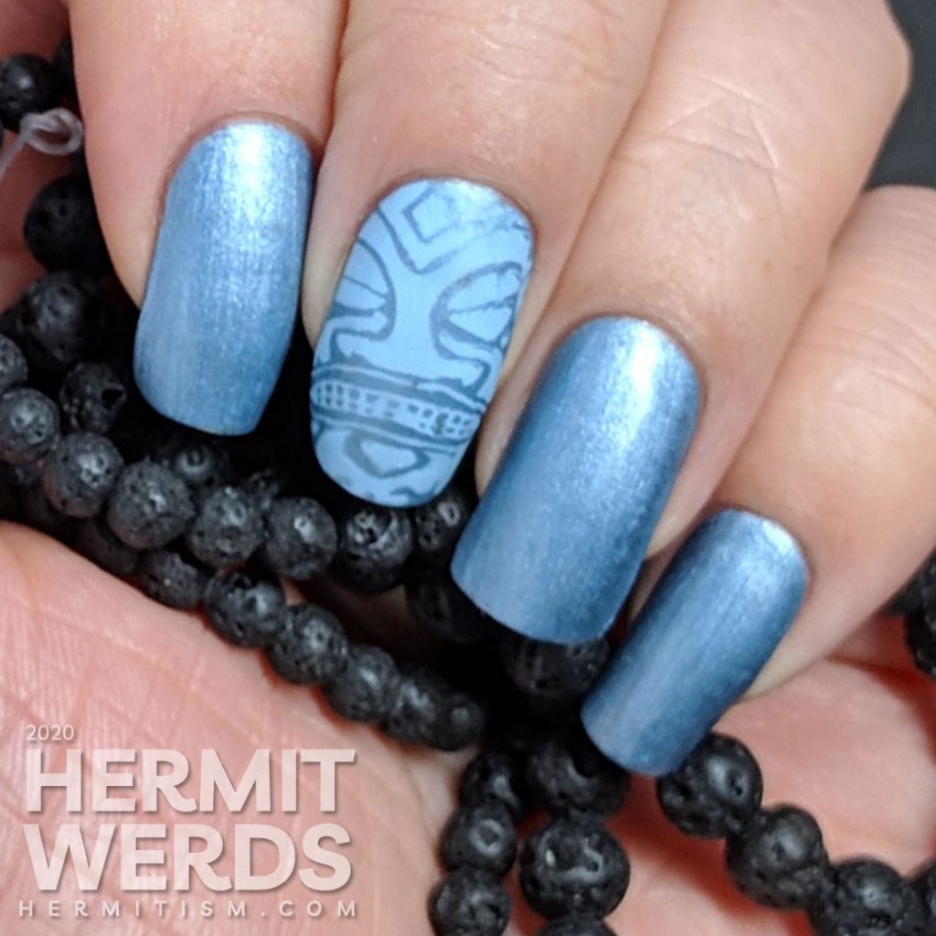 Blue metallic nail art with tribal stamping decals in a light blue.