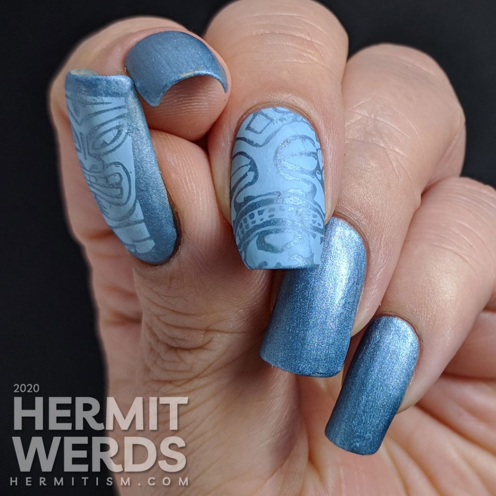 Blue metallic nail art with tribal stamping decals in a light blue.