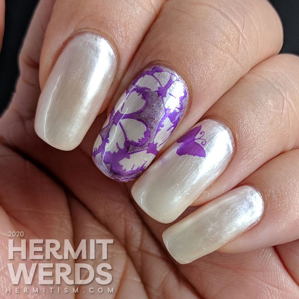 Pearly white/pink sun-activated nail art with purple butterfly stamping.