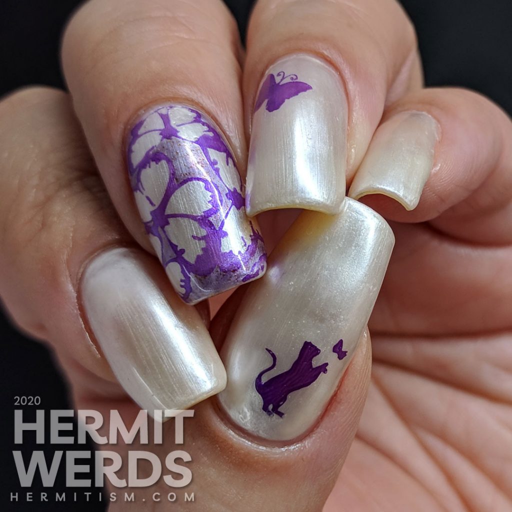 Pearly white/pink sun-activated nail art with purple butterfly stamping.