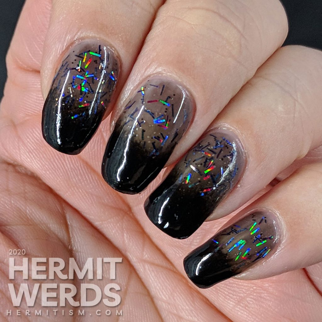 Black baby boomer french tips with rainbowy bar glitter.