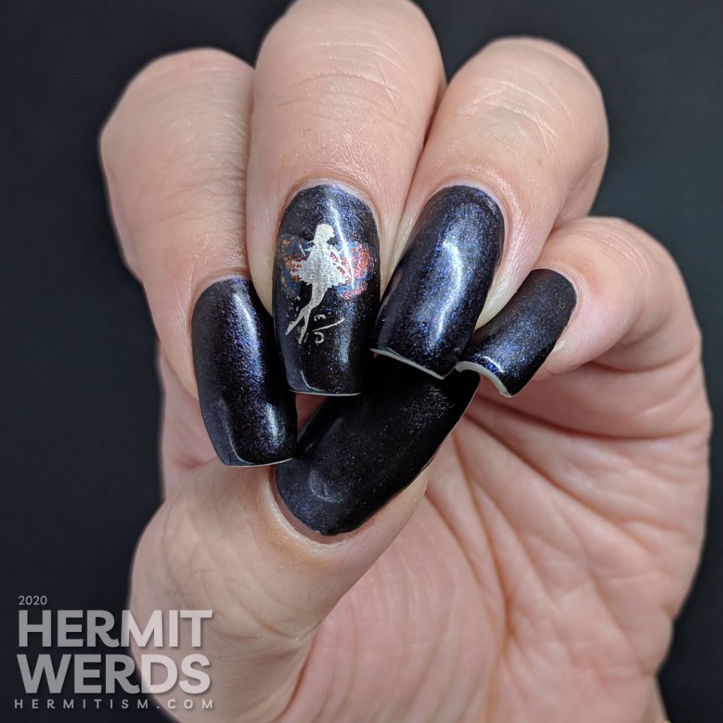 A dark purple mani with a silver fairy with butterfly wings stamped on top.