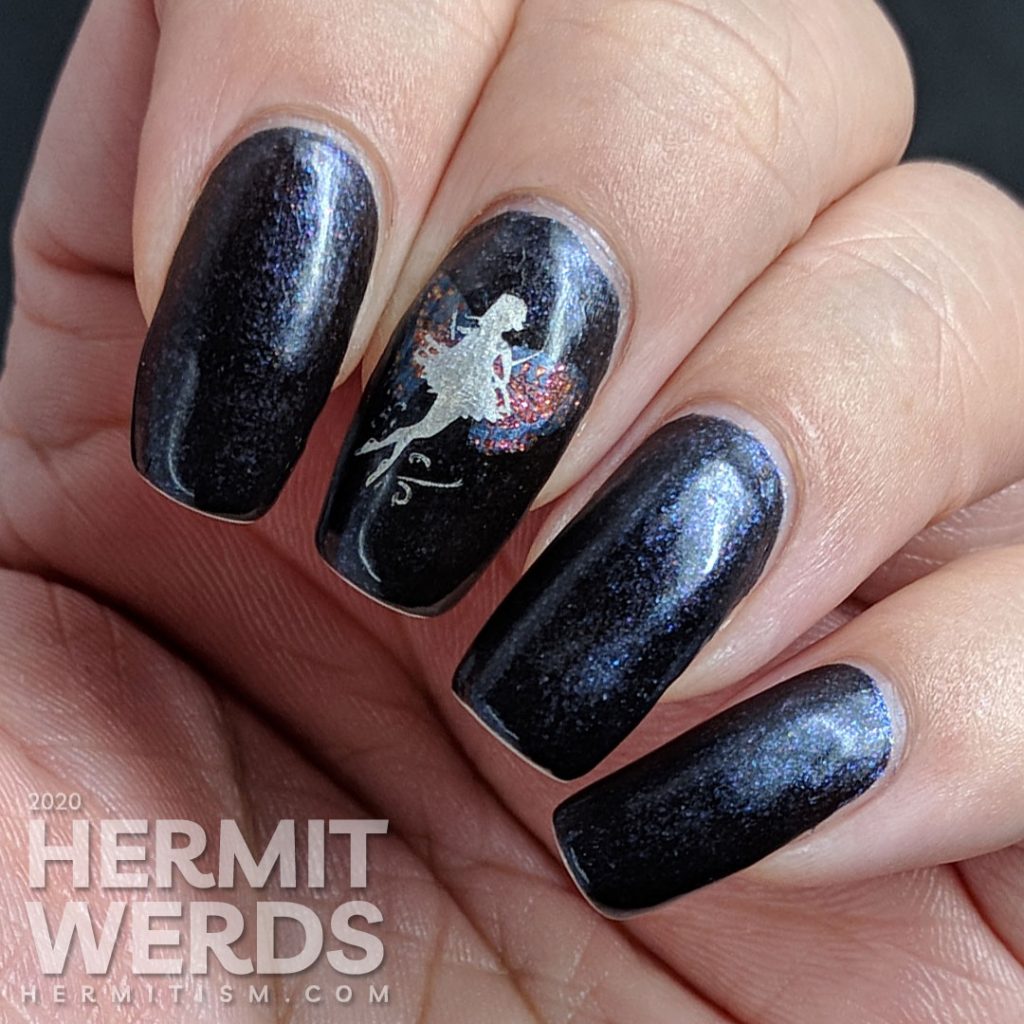 A dark purple mani with a silver fairy with butterfly wings stamped on top.