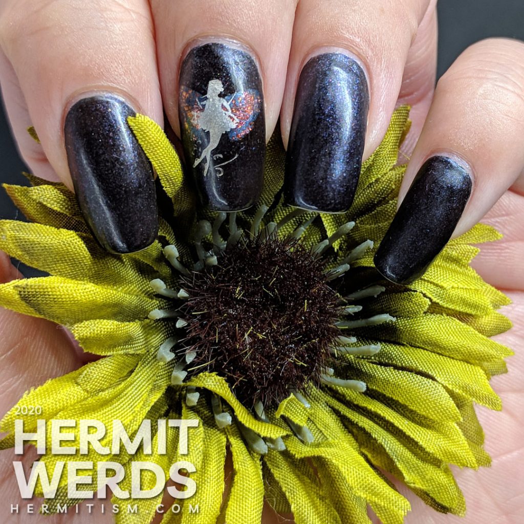 A dark purple mani with a silver fairy with butterfly wings stamped on top.