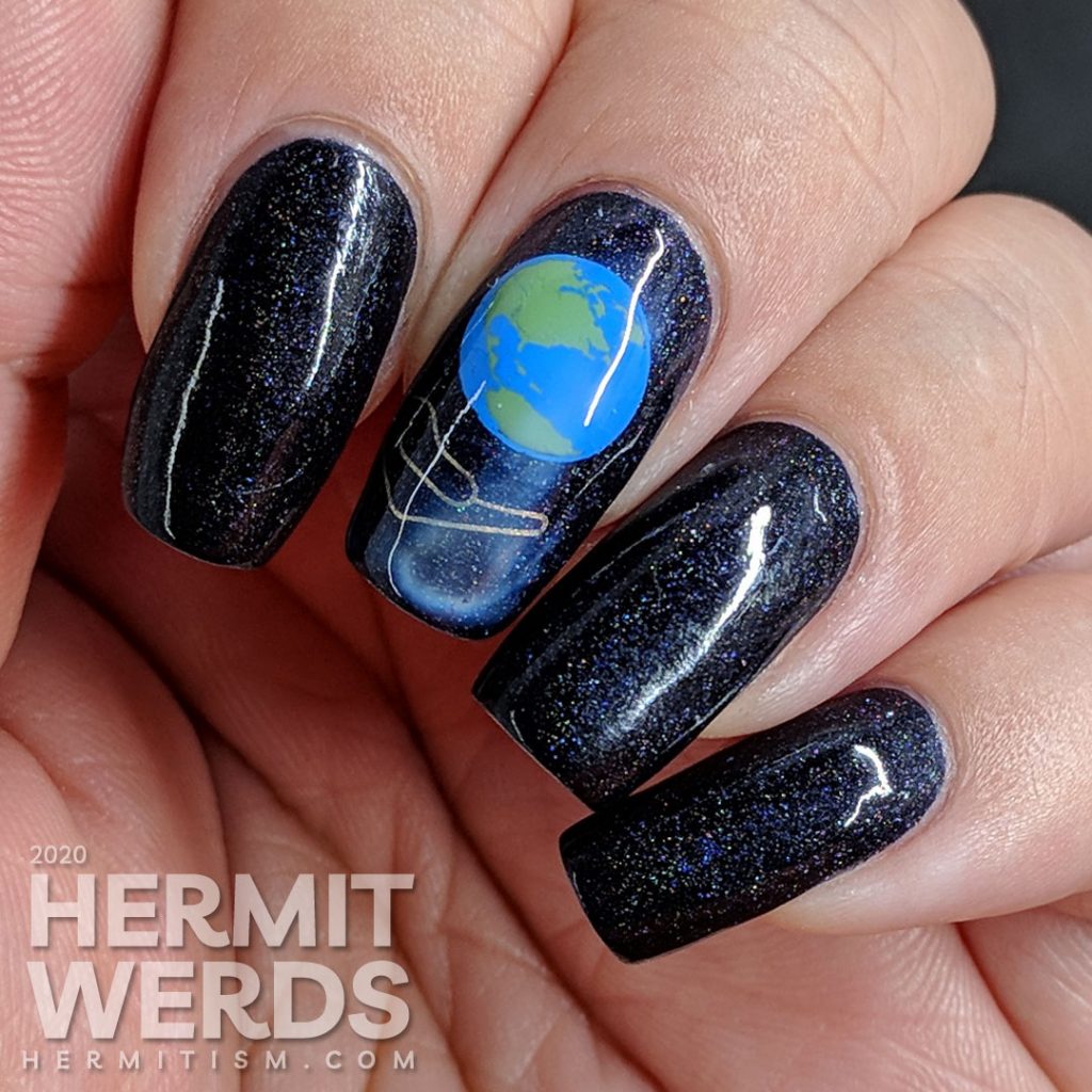 Holographic Earth Day nail art of the Earth being cradled in a human hand.