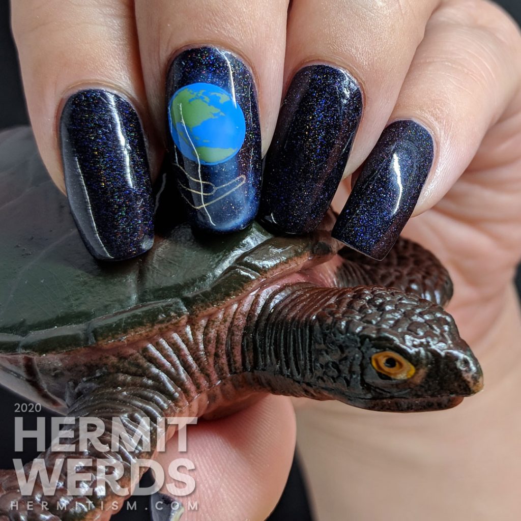 Holographic Earth Day nail art of the Earth being cradled in a human hand.