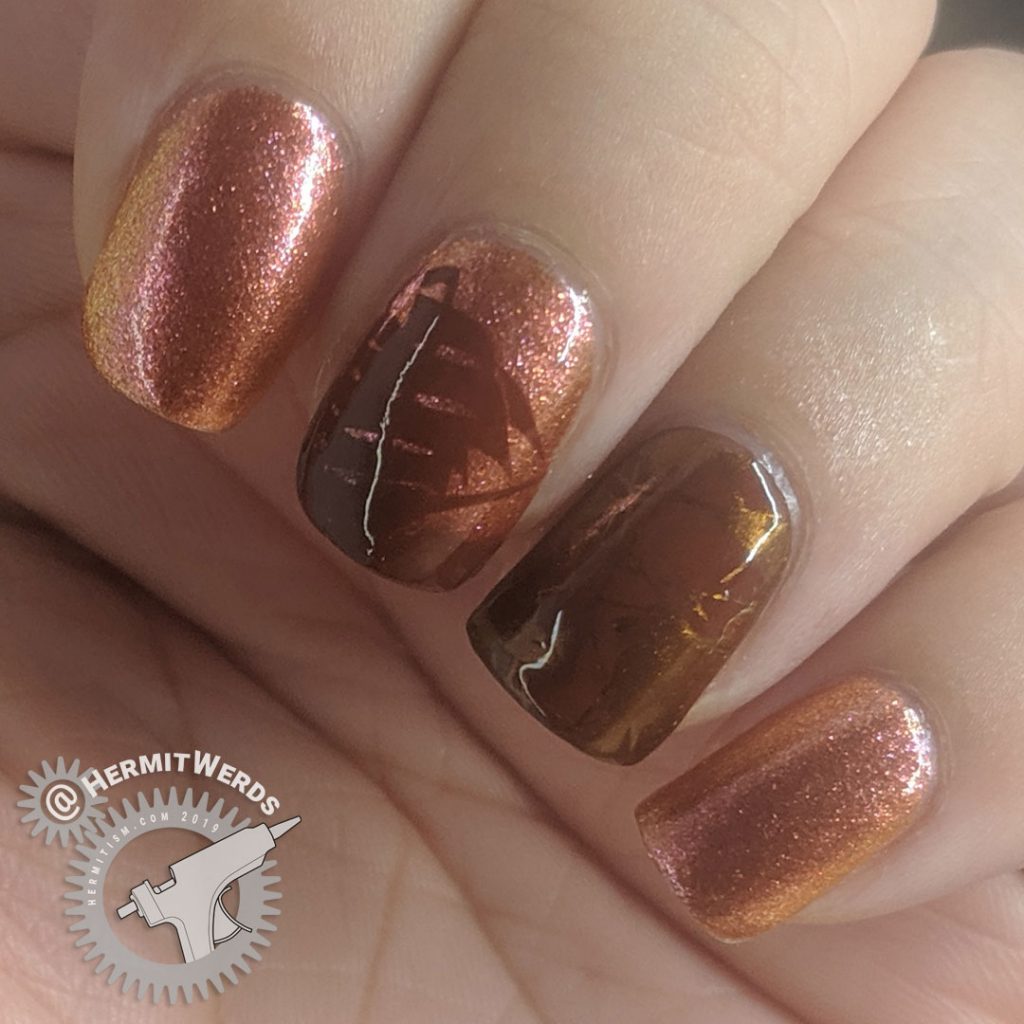 Orange duochrome polish with pirate ship and map stamping decals for Talk Like a Pirate day.