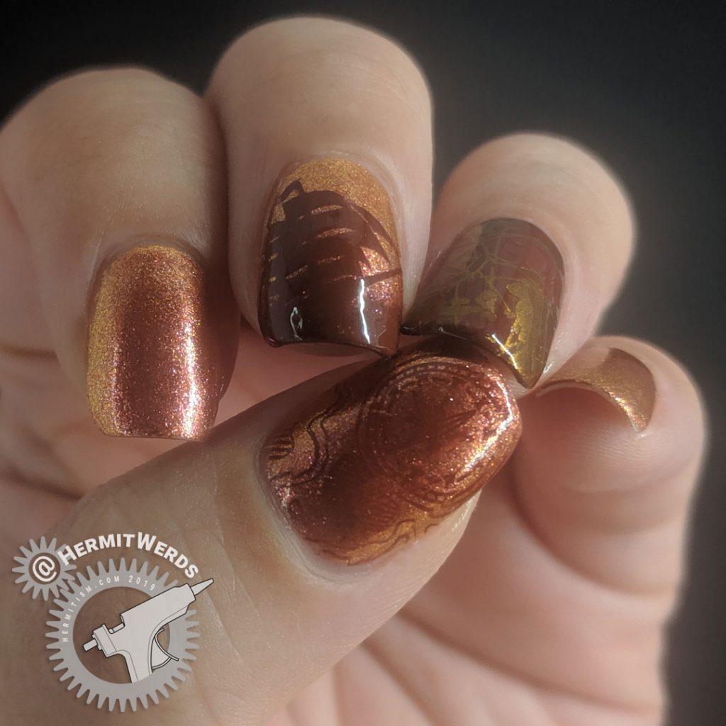 Orange duochrome polish with pirate ship and map stamping decals for Talk Like a Pirate day.