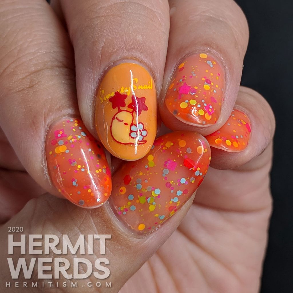 Cute little flower-shelled snail paired with a bright orange to nude crelly polish packed with colorful glitter.