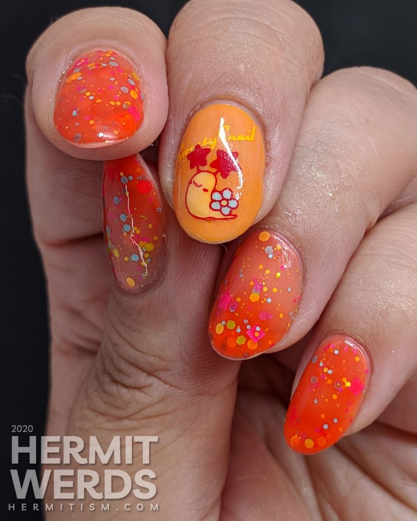 Cute little flower-shelled snail paired with a bright orange to nude crelly polish packed with colorful glitter.