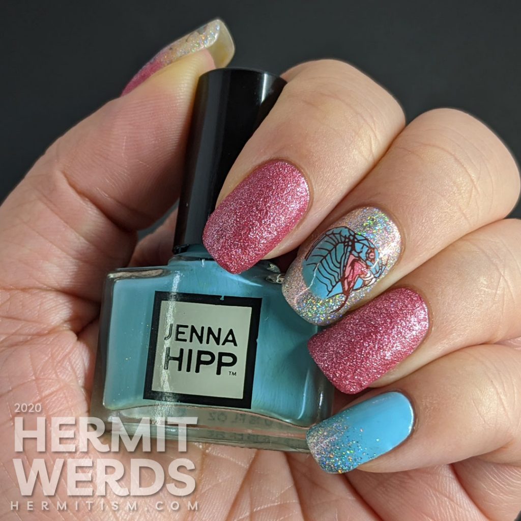 A soft pink and blue nail art decorated with hooded cobra stamping decals and a little dash of the holographic.