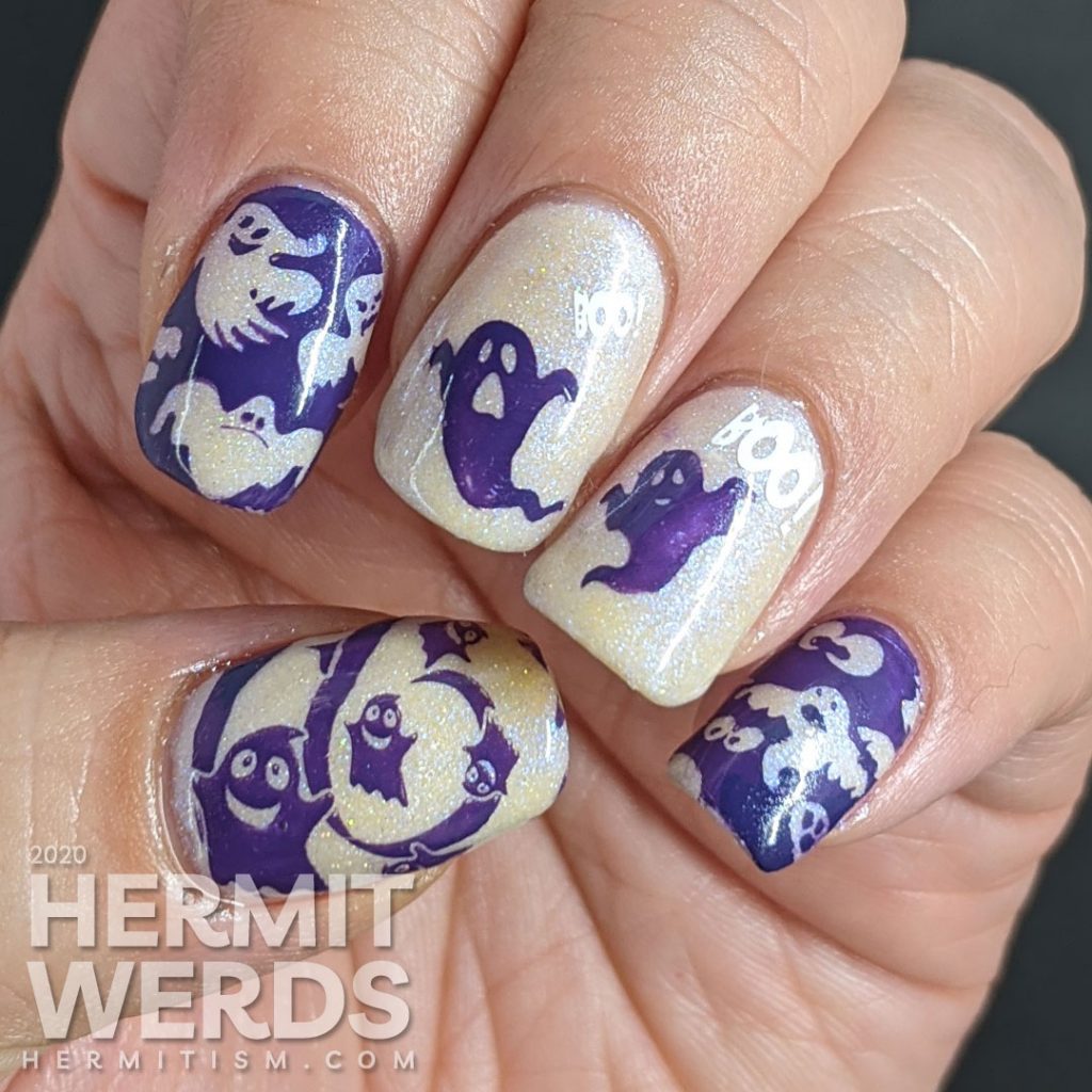 A white and purple ghostly nail art with negative space stamping, boo-ing ghosts and glow in the dark action!