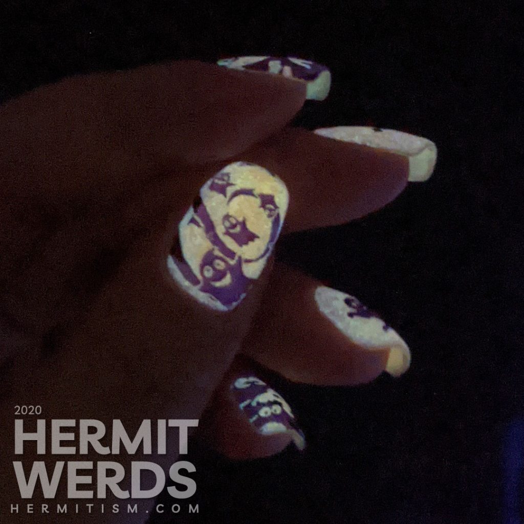 A white and purple ghostly nail art with negative space stamping, boo-ing ghosts and glow in the dark action!