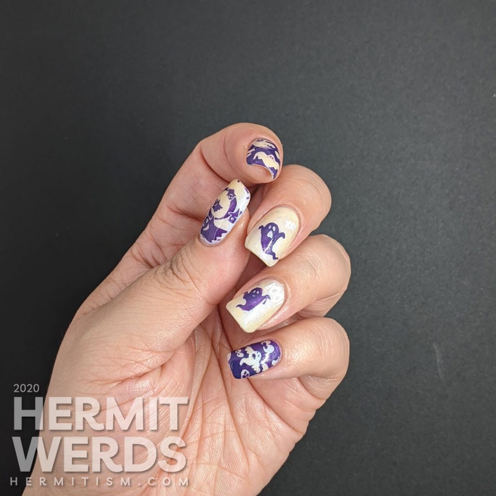 A white and purple ghostly nail art with negative space stamping, boo-ing ghosts and glow in the dark action!