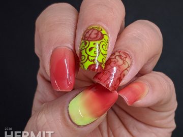 Bright green and coral thermal polish manicure with cute jack-o-lantern pumpkins stamped on top.