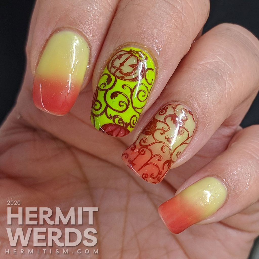 Bright green and coral thermal polish manicure with cute jack-o-lantern pumpkins stamped on top.