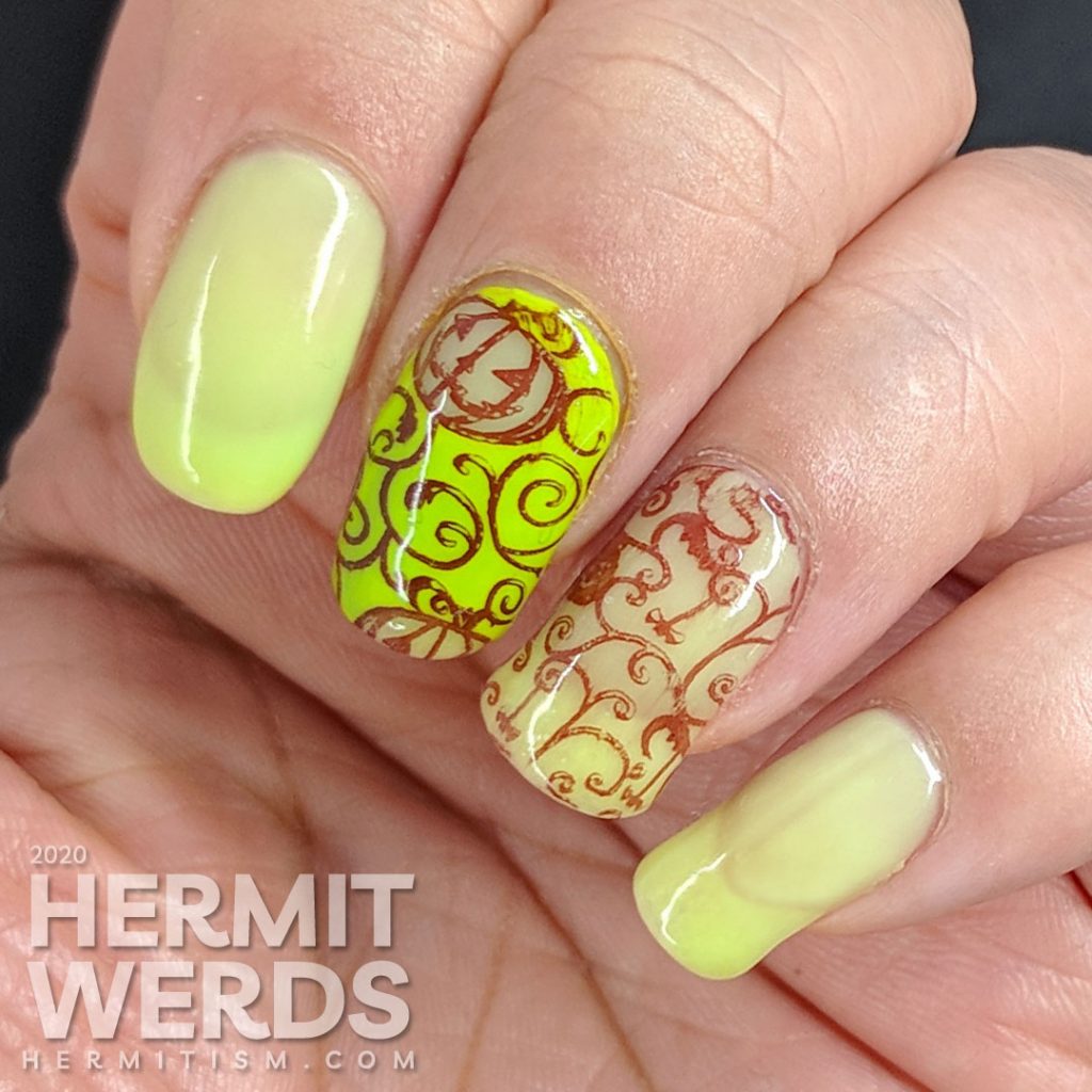 Bright green and coral thermal polish manicure with cute jack-o-lantern pumpkins stamped on top.