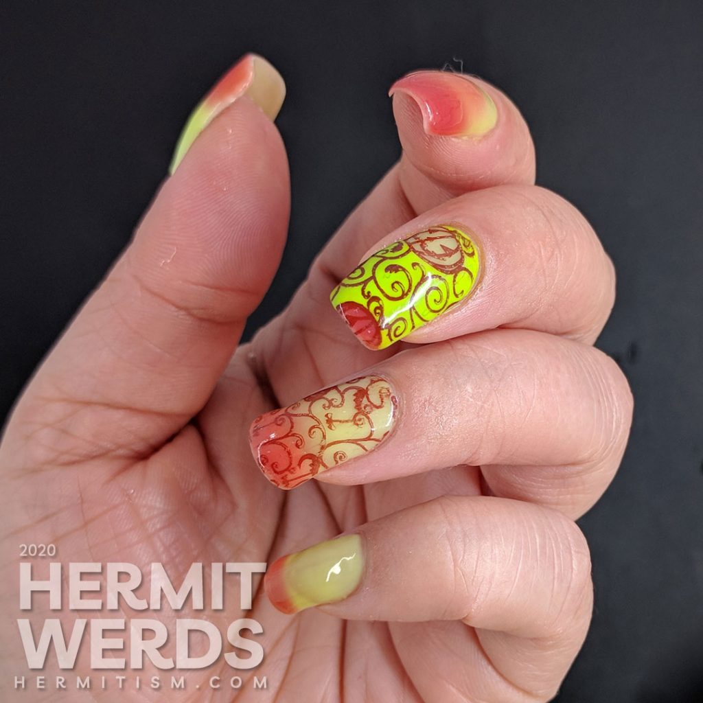 Bright green and coral thermal polish manicure with cute jack-o-lantern pumpkins stamped on top.