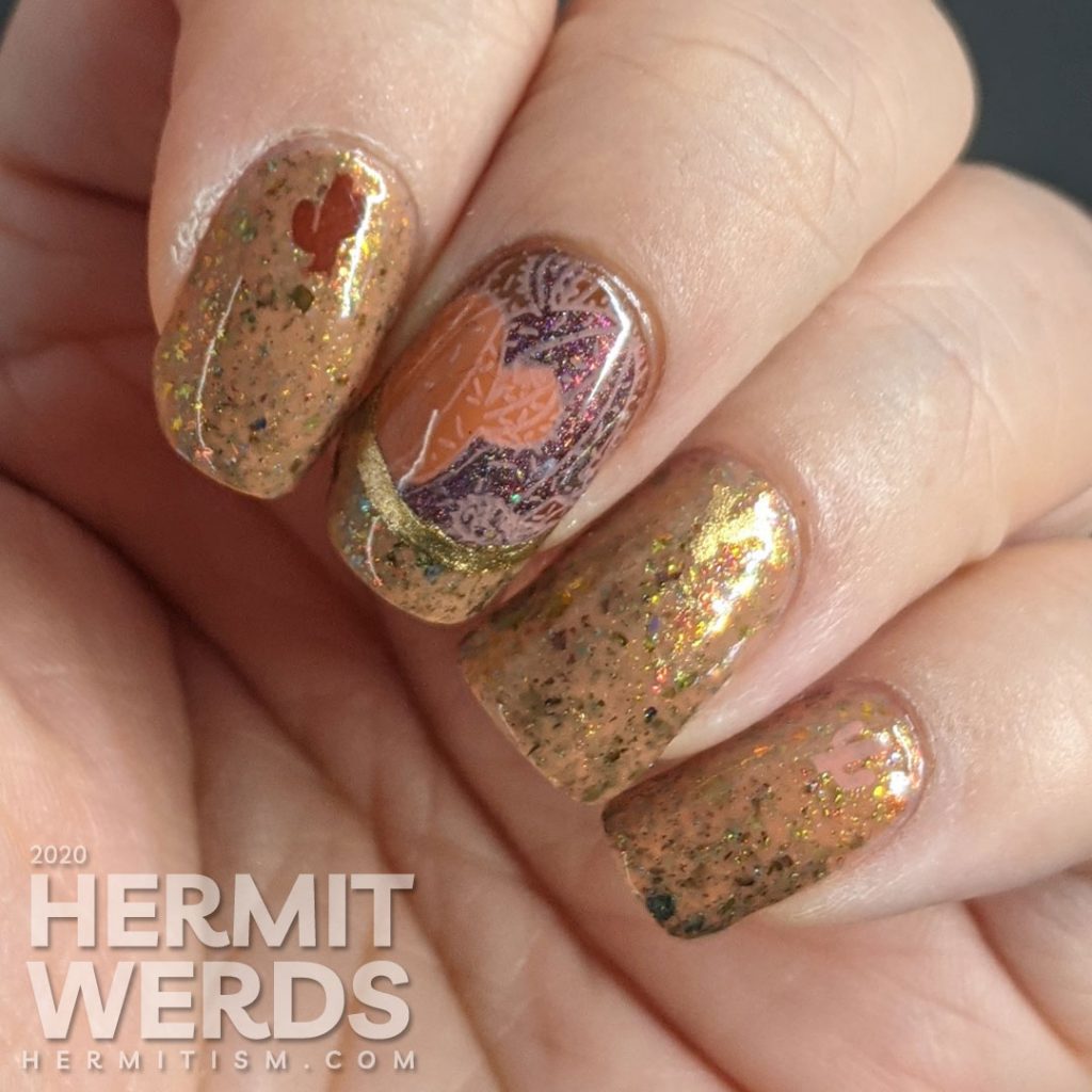 Cactus-themed nail art with a tawny brown and holographic dark red polish and gold geometric frames with potted cacti.