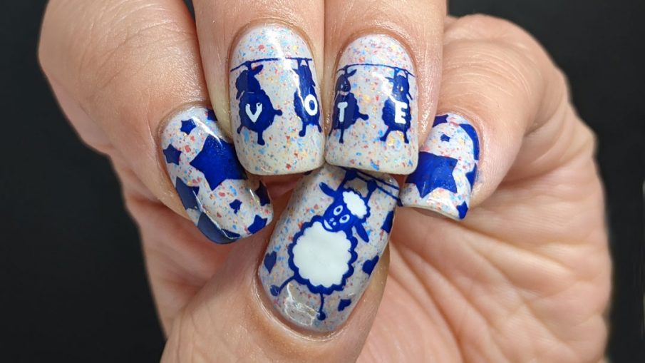 A patriotic red white and blue crelly polish with blue sheep stamped on top and "vote" painted letter by letter on their fluffy sheep bellies.