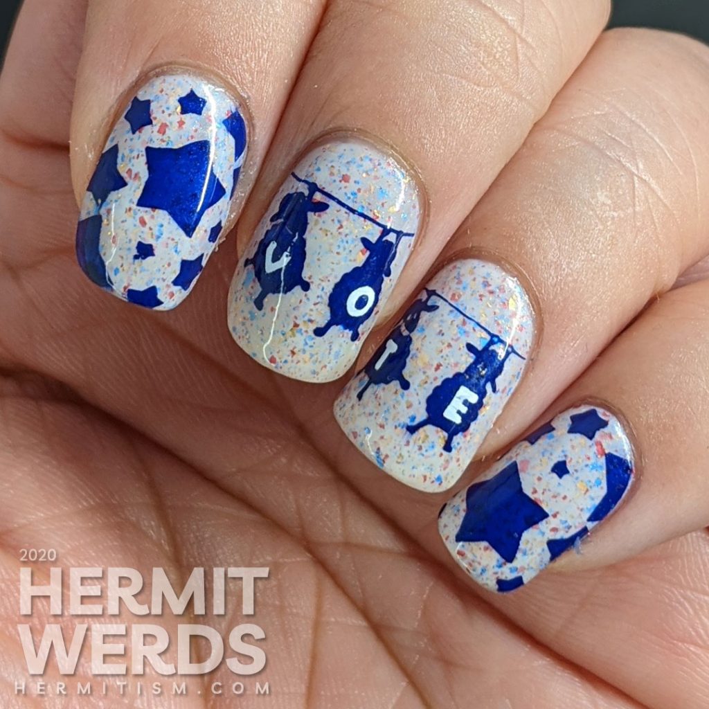 A patriotic red white and blue crelly polish with blue sheep stamped on top and "vote" painted letter by letter on their fluffy sheep bellies.