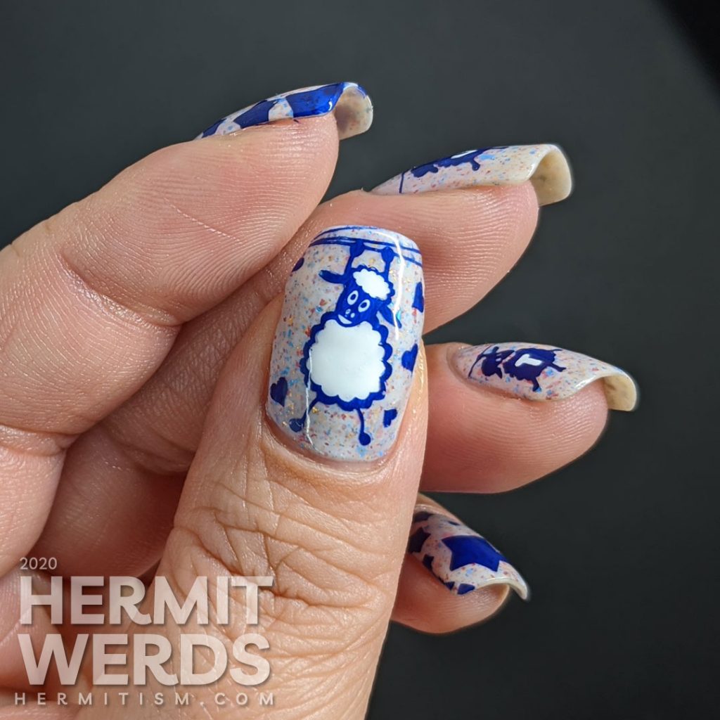 A patriotic red white and blue crelly polish with blue sheep stamped on top and "vote" painted letter by letter on their fluffy sheep bellies.