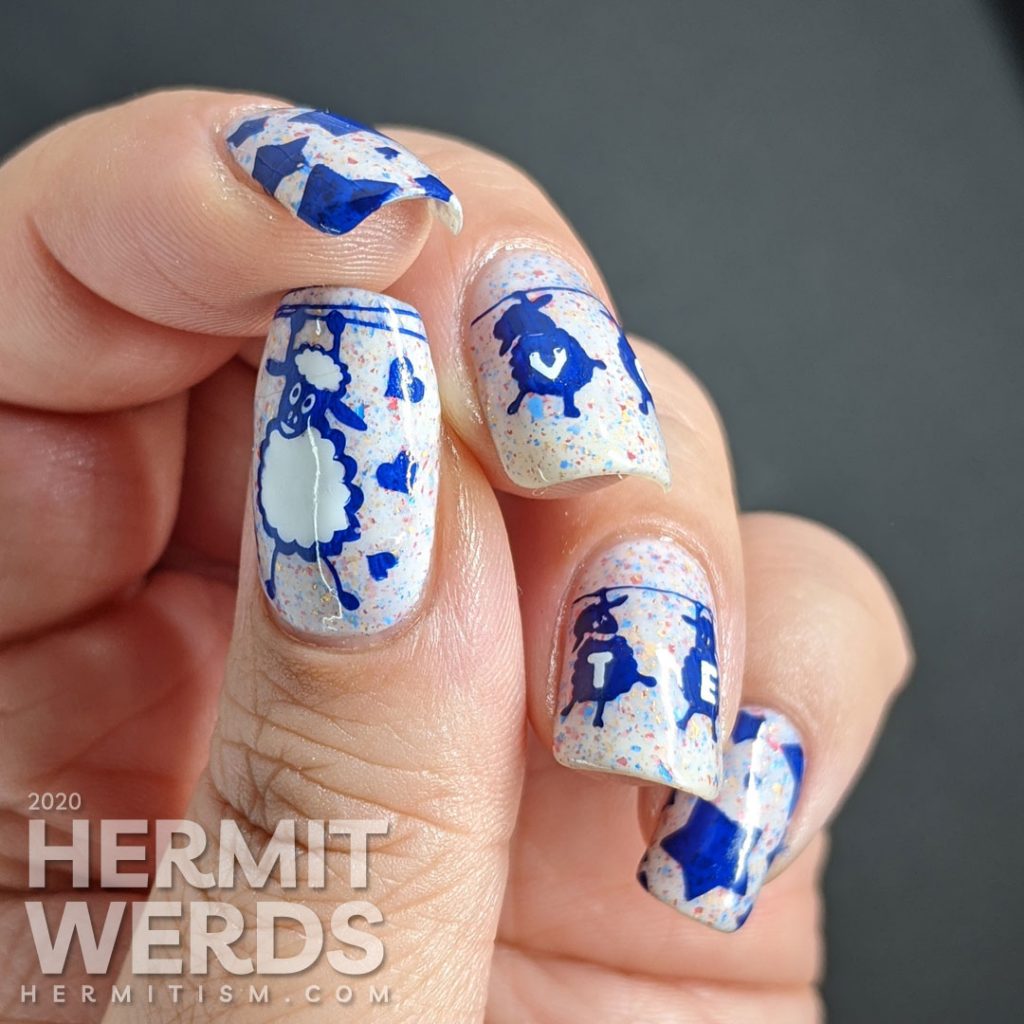 A patriotic red white and blue crelly polish with blue sheep stamped on top and "vote" painted letter by letter on their fluffy sheep bellies.