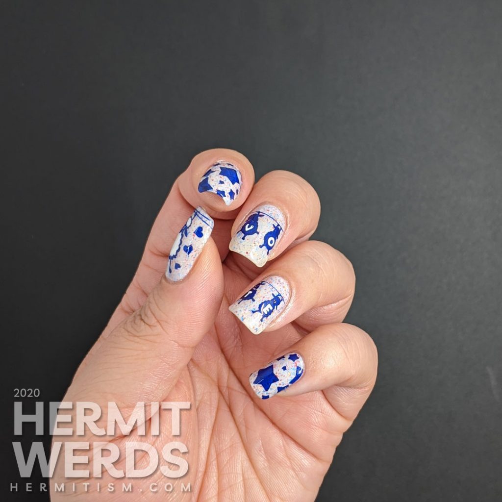 A patriotic red white and blue crelly polish with blue sheep stamped on top and "vote" painted letter by letter on their fluffy sheep bellies.