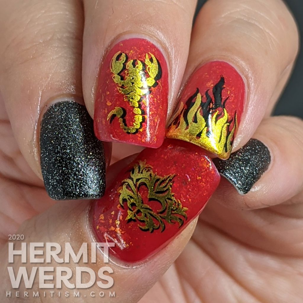 A glow in the dark fire-y thermal red and black nail art with double stamped scorpion and flames and edgy black textured polish accent nails.
