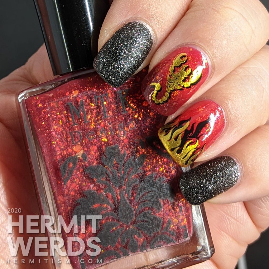 A glow in the dark fire-y thermal red and black nail art with double stamped scorpion and flames and edgy black textured polish accent nails.