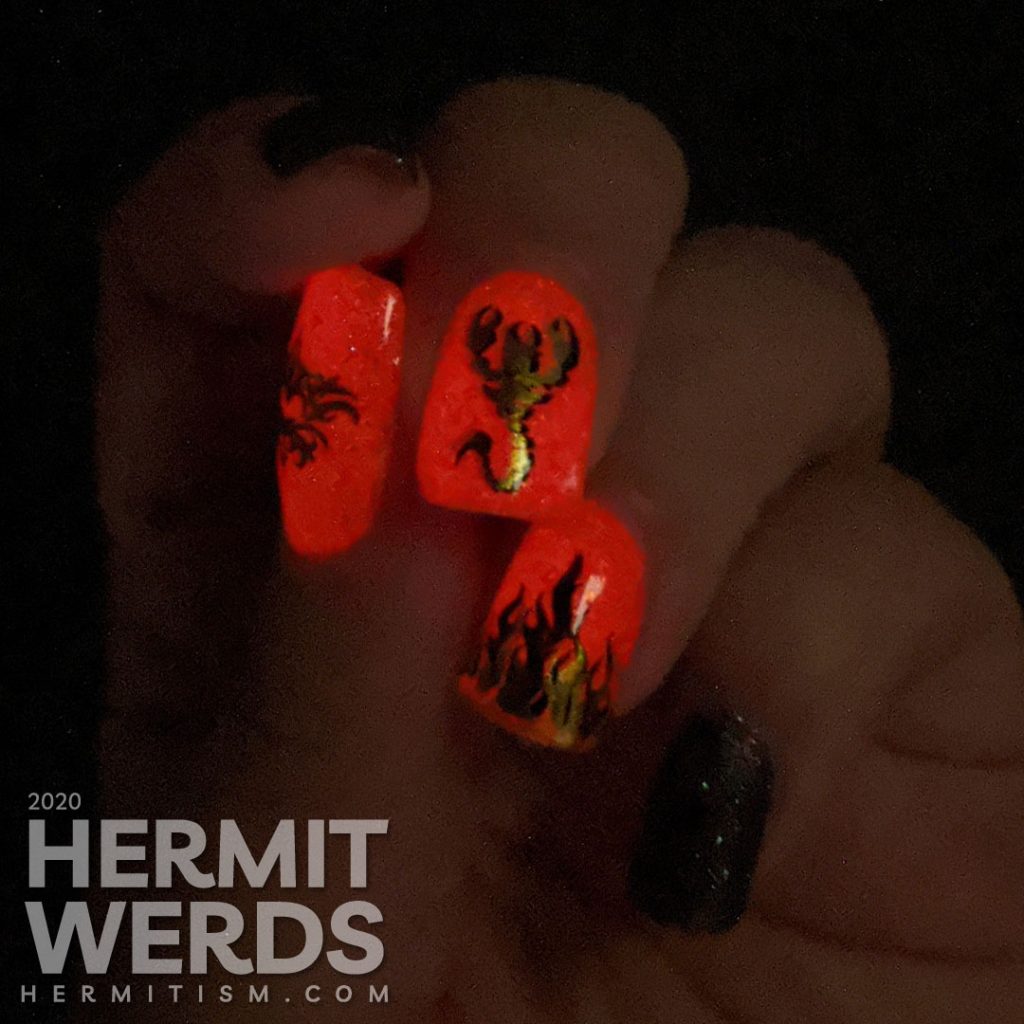 A glow in the dark fire-y thermal red and black nail art with double stamped scorpion and flames and edgy black textured polish accent nails.