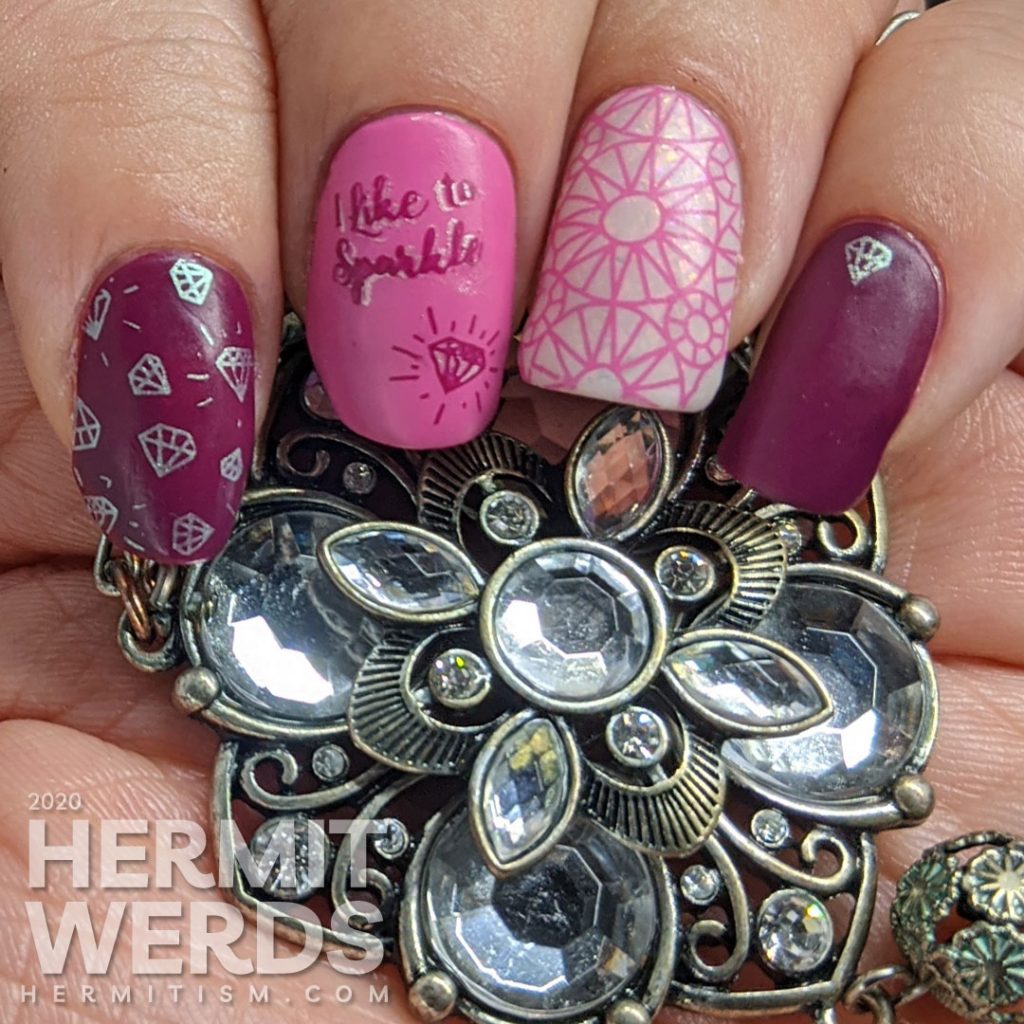 Diamond themed nail art in pinks and purples with an iridescent white crelly accent nail that is covered in faceted gem stamping. "I like to sparkle."