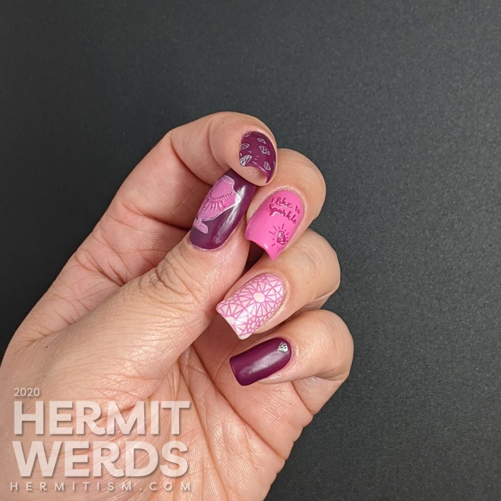 Diamond themed nail art in pinks and purples with an iridescent white crelly accent nail that is covered in faceted gem stamping. "I like to sparkle."