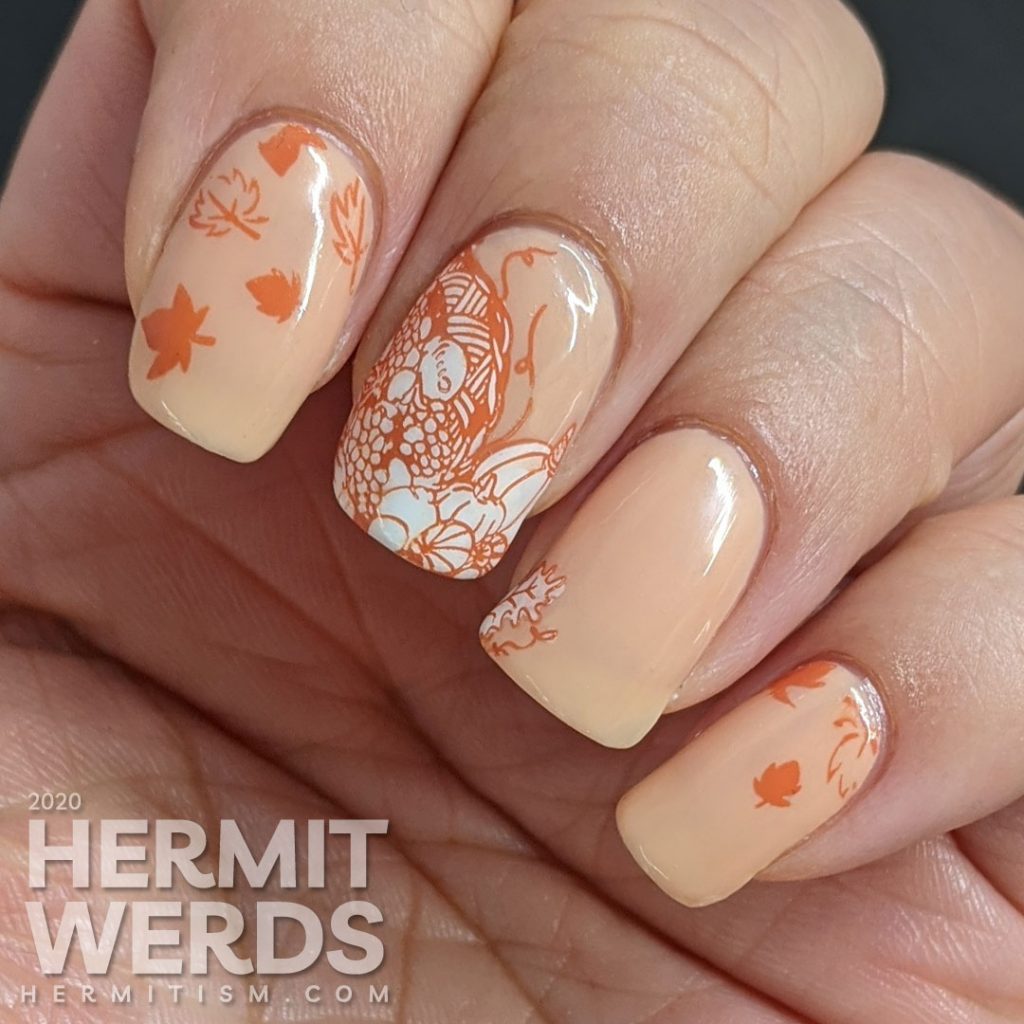 A simple fall nail art with stampings of leaves, pumpkins, and other harvest-related items on an apricot jelly polish background.